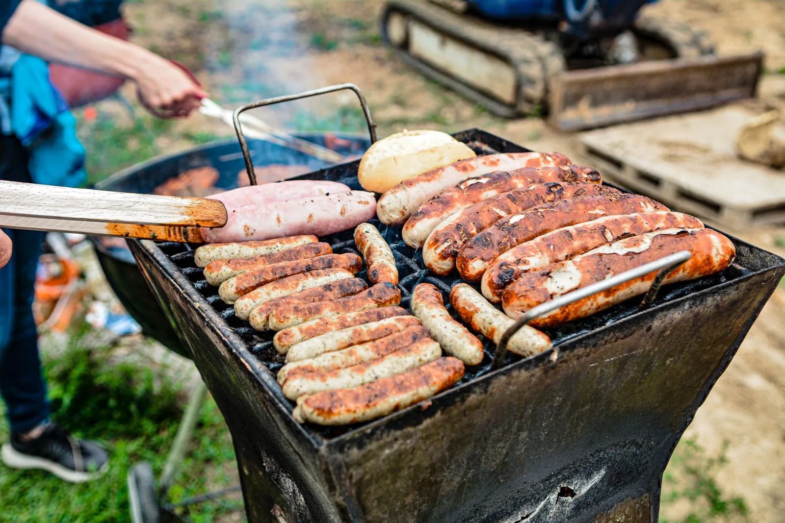 Sausages and bread cooking on a barbecue at a fundraiser