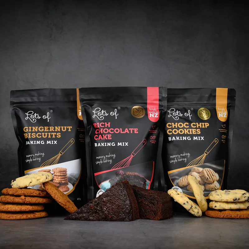 Lots of Baking Mixes packets with baked cookies and chocolate cake